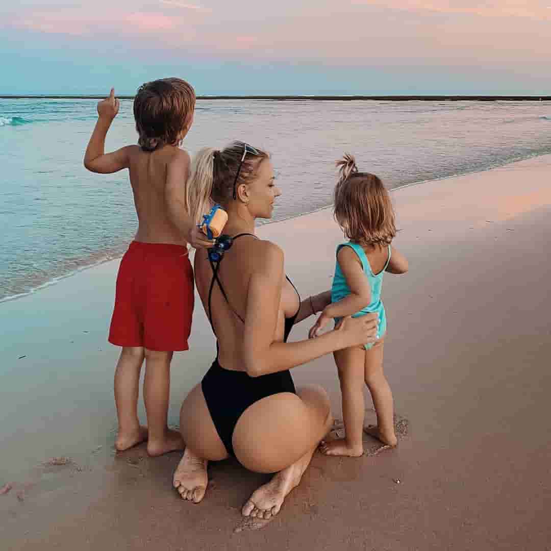 Ekaterina Novikova with her son and daughter on a beach.