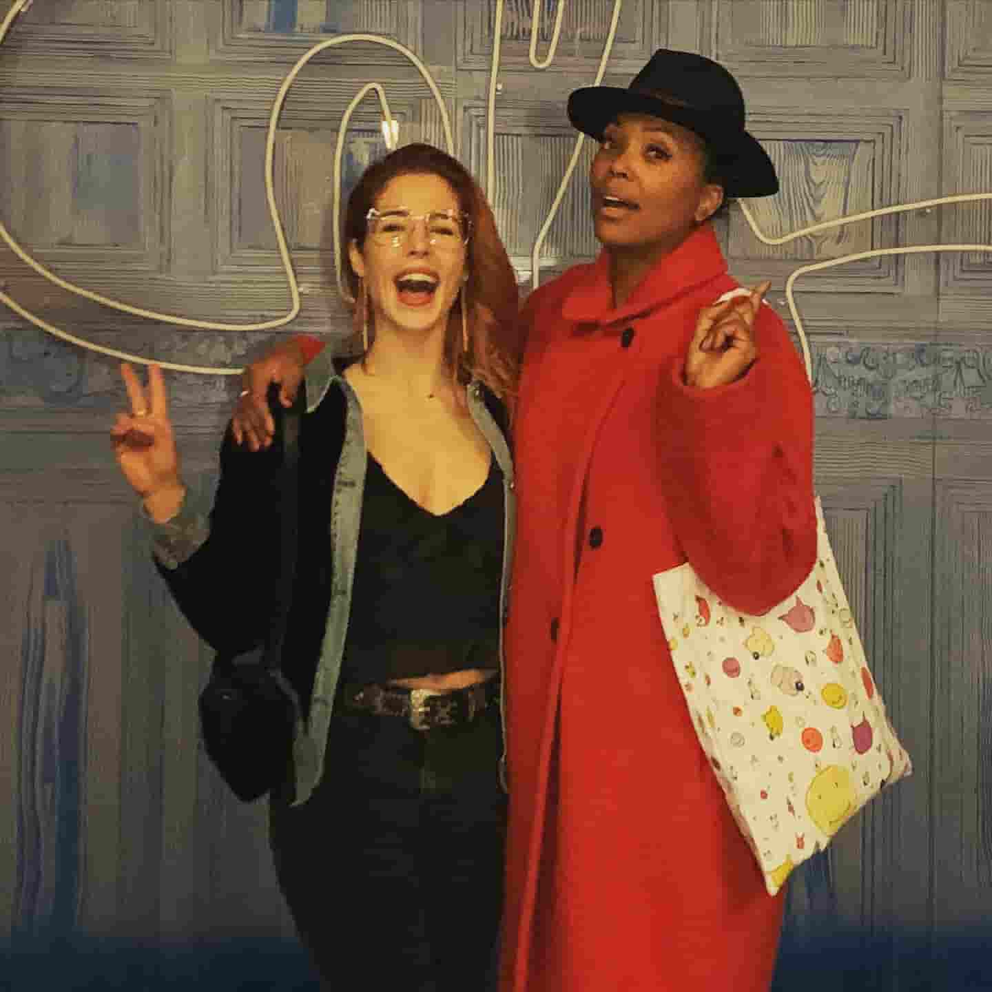 Emily Bett Rickards with Ayesha Tyler having good time together.