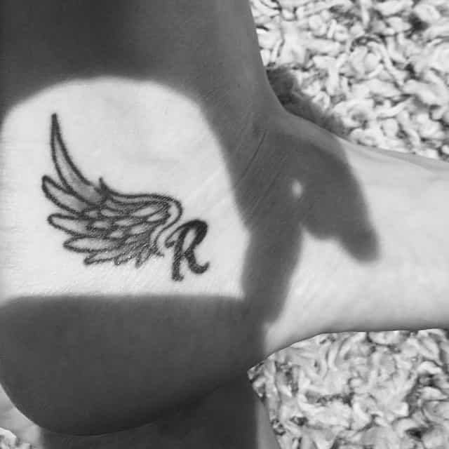 Aimee Pretson tattoo of half wings and R initial.  