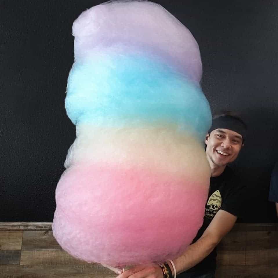Matt Stonie holding the largest Cotton candy.